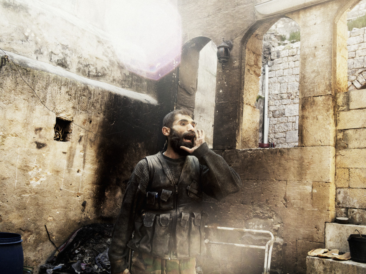 Aleppo, Syria. March, 2013. A rebel yells “Allahu Akbar” (God is Great) during close-quarters fighting in Aleppo’s Old City.