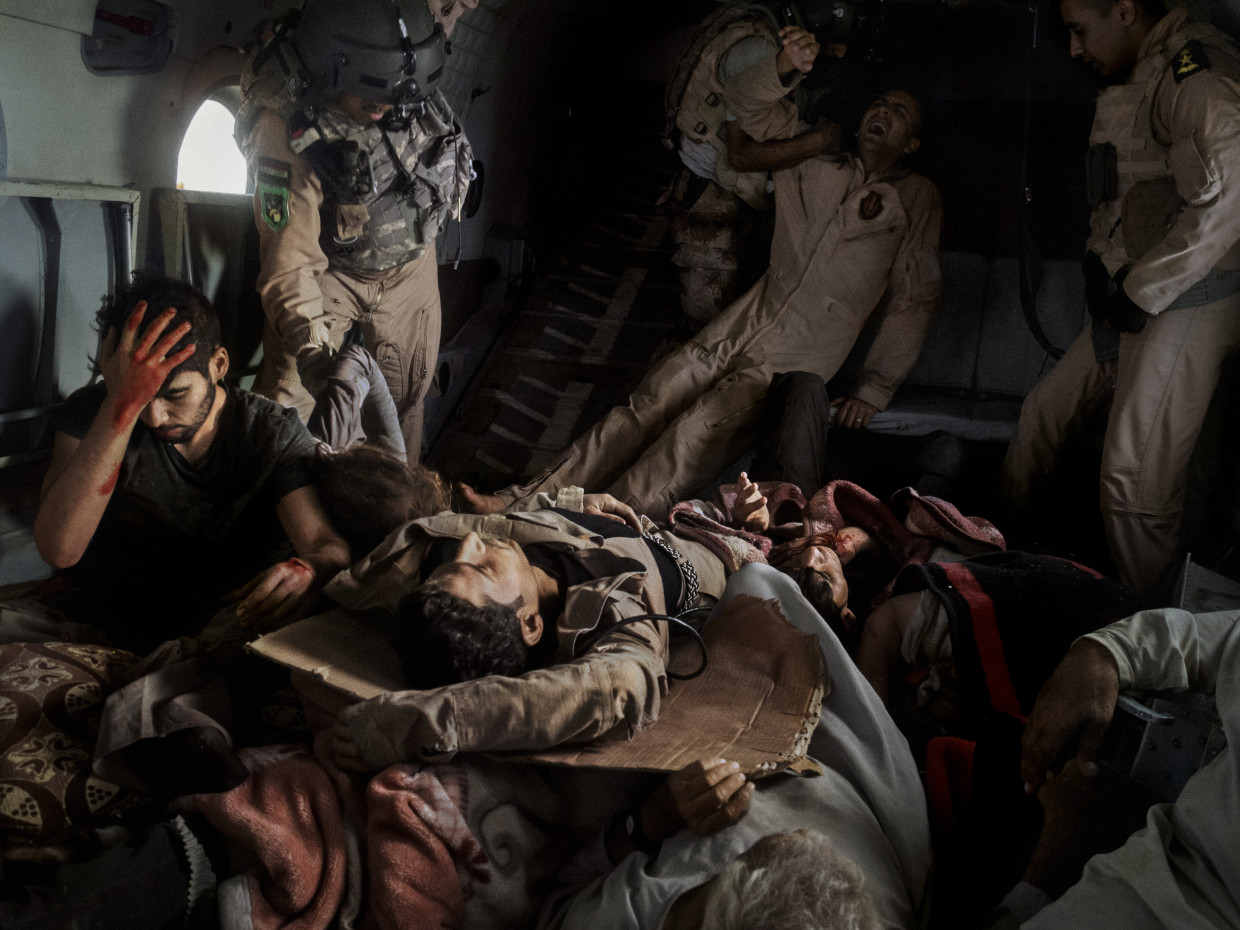 Sinjar, Iraq. August, 2014. Injured survivors of a helicopter crash in Mount Sinjar are evacuated to safety in an Iraqi Air Force rescue helicopter.