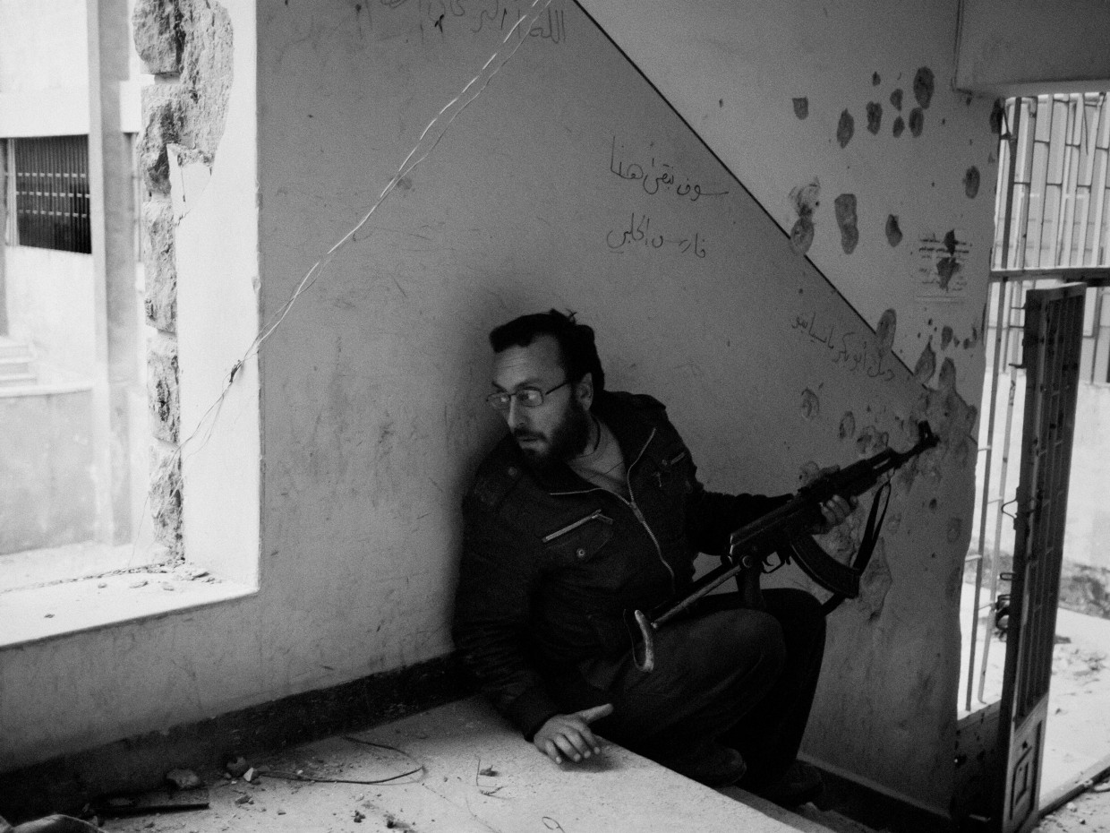 Aleppo, Syria. March, 2013. A rebel fighter takes cover inside a school during fighting between rebel forces and regime soldiers in Aleppo.