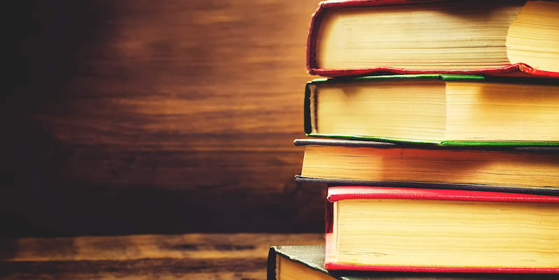 Eman Quotah, stack of books, feature image