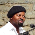 Ben_Okri_in_Tallinn.jpg by Metsavend, CC BY-SA 3.0 <https://creativecommons.org/licenses/by-sa/3.0>, via Wikimedia Commons